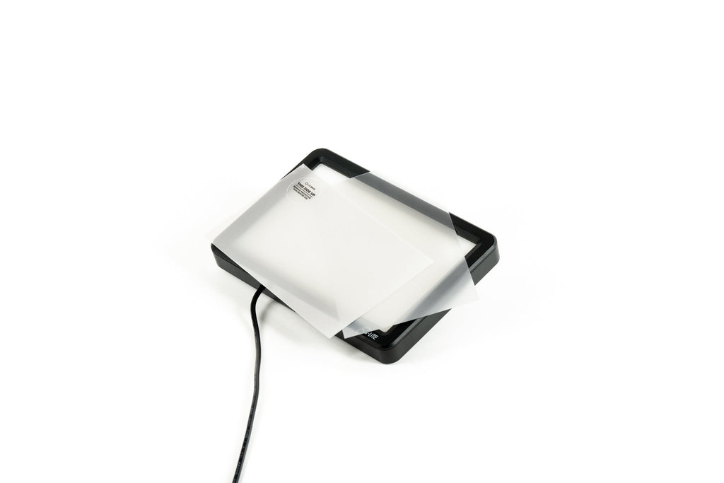 Cinestill CS-LITEBRITE+ 2.3x Light Booster with enhancement sheets on a white background.