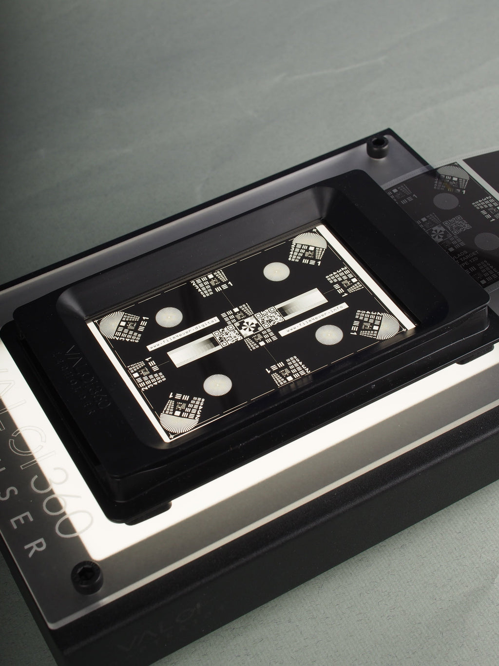 Vlad's Test Targets close-up with on a metallic grey background.