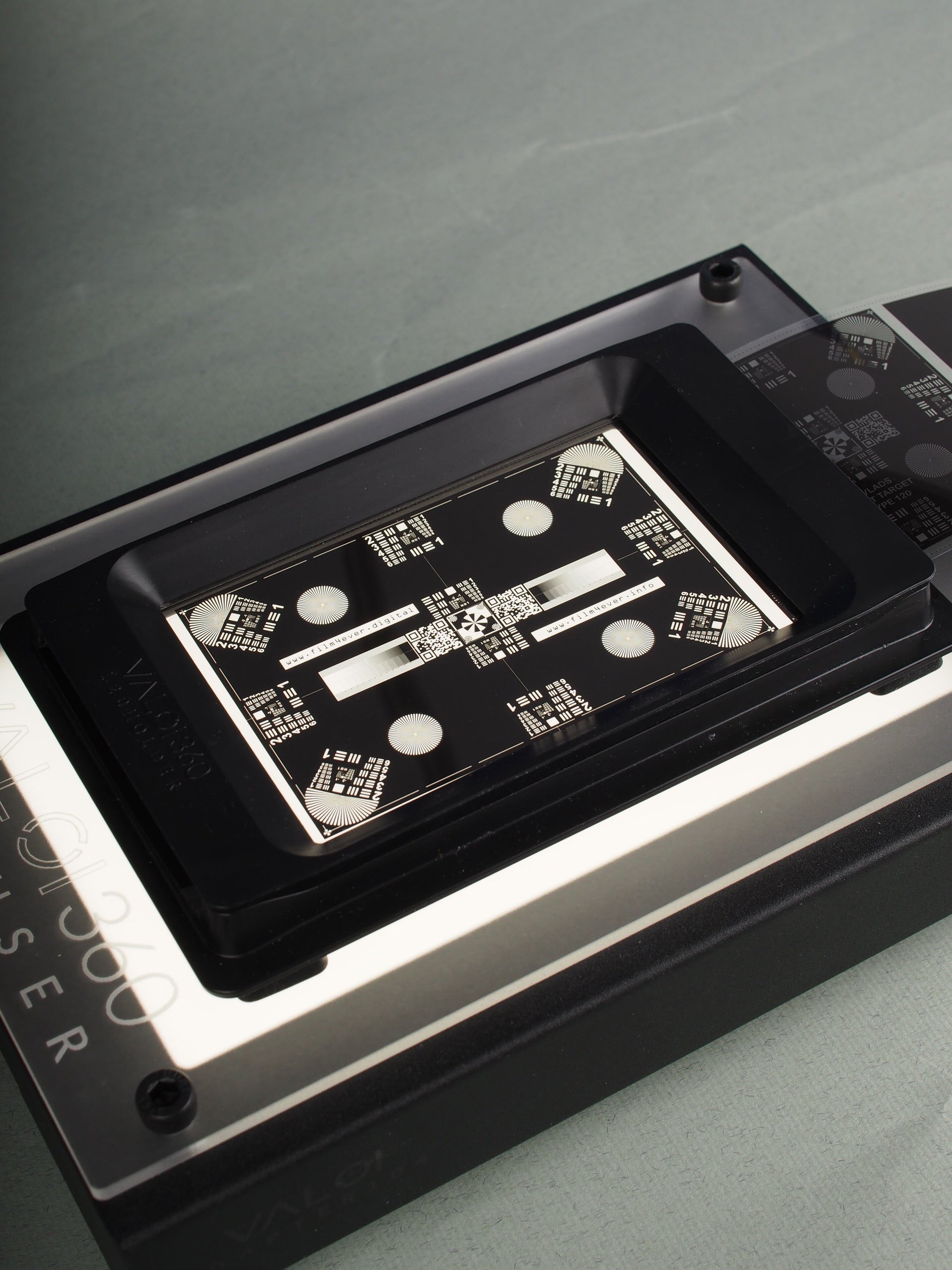 Vlad's Test Targets close-up with on a metallic grey background.