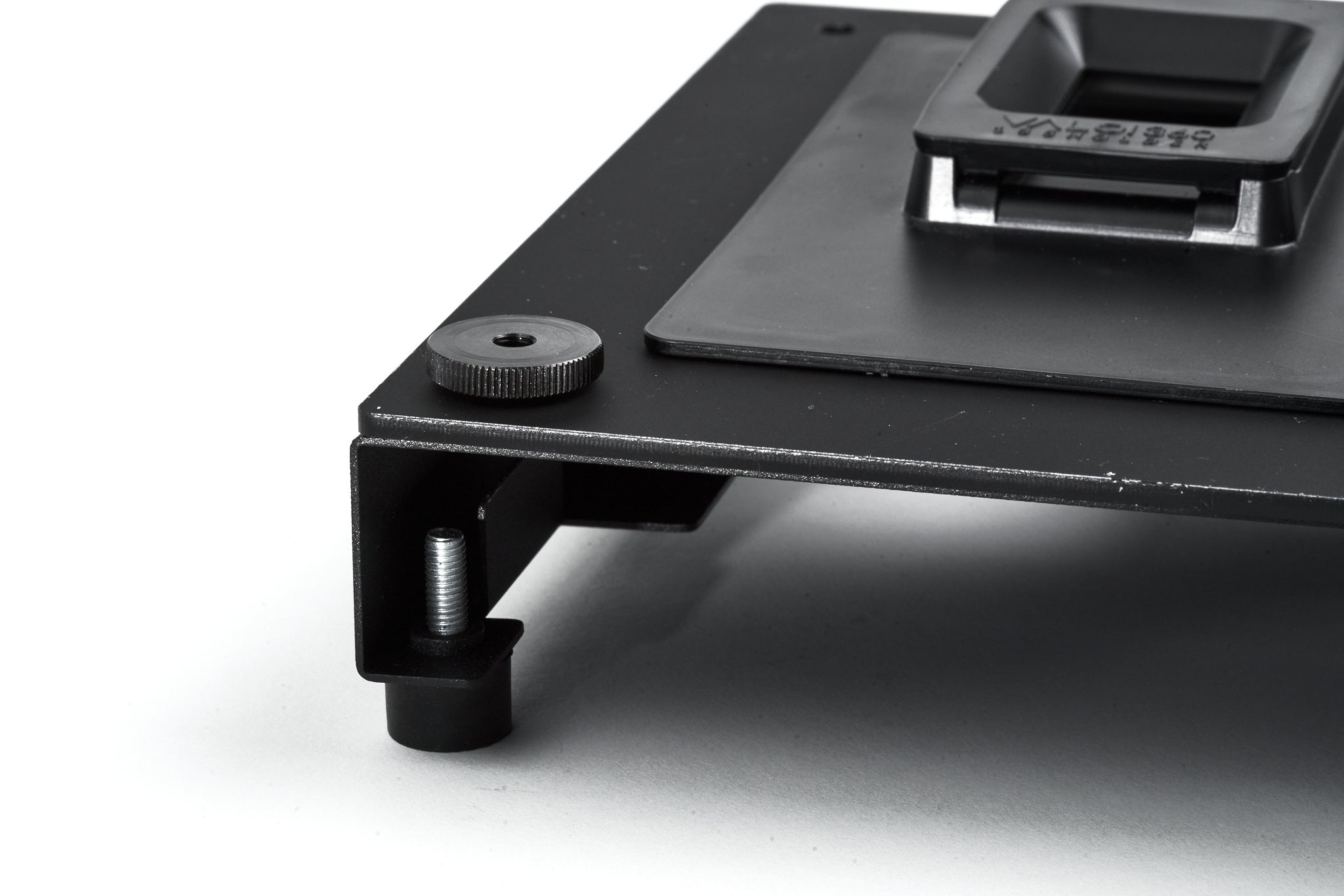 A close-up of a Holder Plate attached to an adapter on a white background.