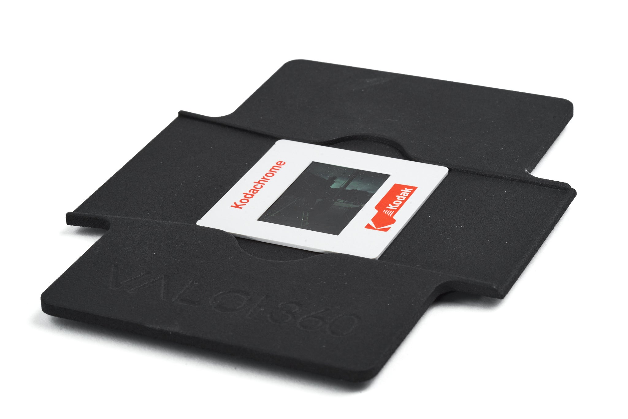 VALOI 360 Slide Holder close-up with a slide on a white background.